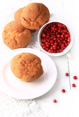 muffins with cranberries on a wooden white background selective focus pastries