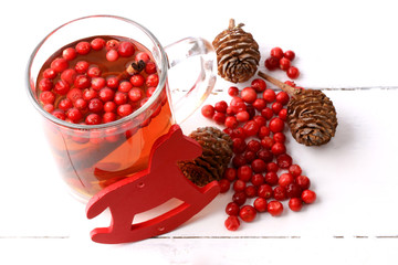 Christmas tea with cranberry Christmas decorations cones grog cider winter white wooden background...