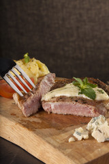 steak, a prepared piece of steak cut with blue cheese sauce on dining table decorated