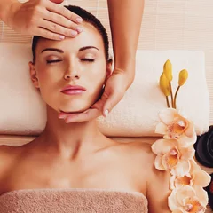 Poster Masseur doing massage the head of an woman in spa salon © Valua Vitaly