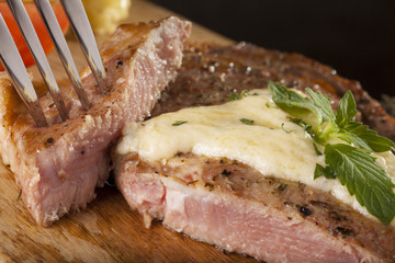 steak, a prepared piece of steak cut with blue cheese sauce on dining table decorated