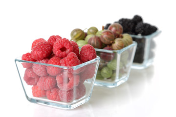 Raspberry, blackberry and gooseberry in glass cups