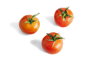 Three red tomatoes isolated on white.