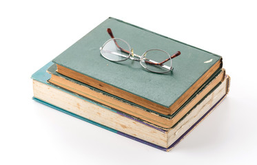 old book with glasses on white background