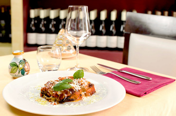 eggplant parmigiana at the table