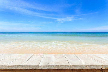 Empty top of wooden table or counter and view of tropical beach