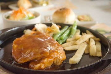 steak and chips on black plate