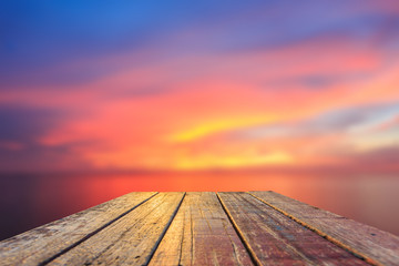 Naklejka na ściany i meble Top of old wooden table with blur sunset background