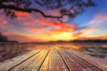 Fototapeta na wymiar Top of old wooden table with blur sunset background