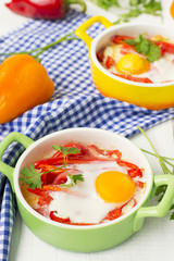 Baked eggs with cheese, tomatoes and peppers.