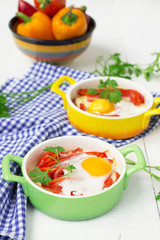 Baked eggs with cheese, tomatoes and peppers.