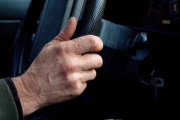за рулём/рука пожилого мужчины держит руль автомобиля © muromec84
