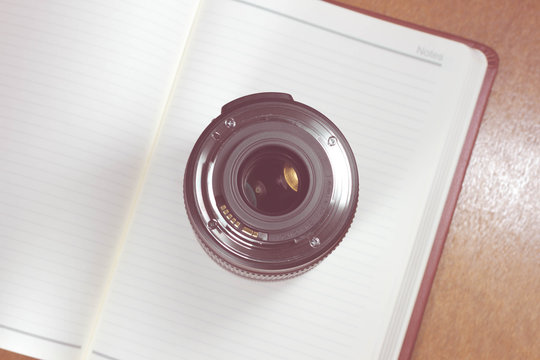 Camera photo lens on notebook ,concept photography  - Vintage effect style pictures