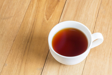 tea in mug on wooden board