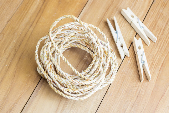 roll rope and wood clothespin on wooden board