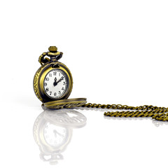 Vintage pocket watch on white background with reflection.