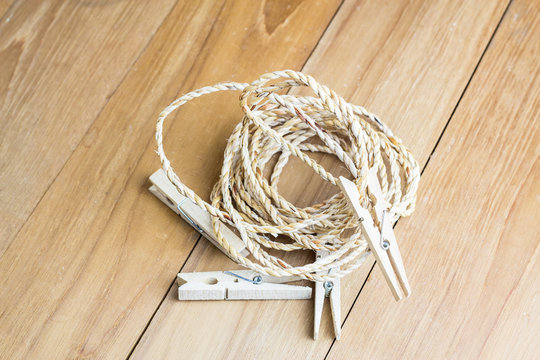 roll rope and wood clothespin on wooden board