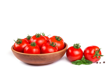 Fresh tomatoes in a bowl with basil isolated