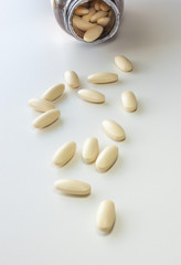 Pour off vitamin on a white background
