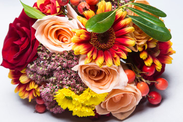 Autumn wedding bouquet close up with flowers and berries. 