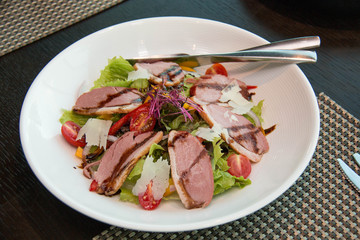  Salad with arugula and duck breast.