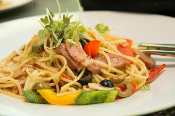 fried Spaghetti with bacon  and peper on plate
