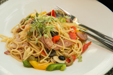 fried Spaghetti with bacon  and peper on plate