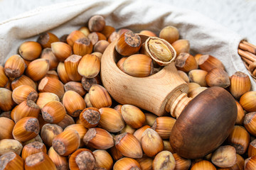  Many hazel nuts and wood cracker in wicker basket 