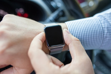 man driving a car with watch on the hand