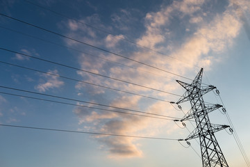 A long line of electrical transmission towers (electricity pylon