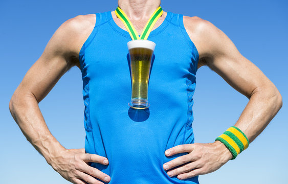 Octoberfest athlete standing with first place gold medal in the shape of a glass of beer standing in front of blue sky