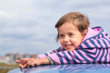 Fototapeta premium little girl smiling and showing something