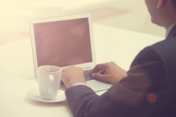 business man using laptop with coffee in the morning