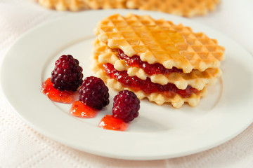 Golden waffles with raspberries and jam