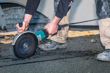 man sawing wood and asphalt 