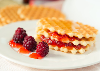 Golden waffles with raspberries and jam