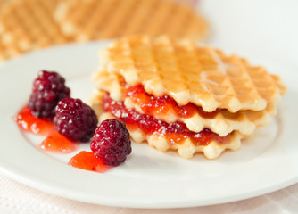 Golden waffles with raspberries and jam