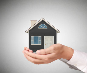 holding house representing home ownership