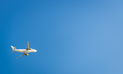 Airplane in the blue sky. Departure from Ibiza airport