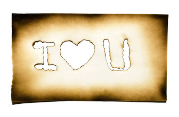 Burned paper with heart and "i love you" text in burned hole