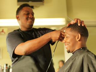 man getting his hair cut at barber shop