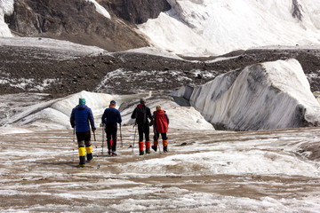 Mountaineers Walking Across Large Glacier
Group of Mountain Climbers with High Altitude Boots and Clothing Crossing Ice Section During Ascent of Alpine Expedition in Asia Mountain Area