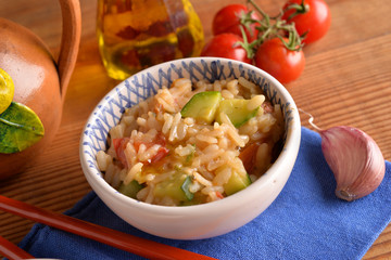 bowls of rice with cherry tomatoes and zucchini with chili oil