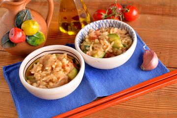 bowls of rice with cherry tomatoes and zucchini with chili oil