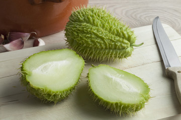 Whole and half fresh spined chayote fruit