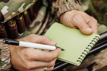 hunter in camouflage clothes ready to hunt with hunting rifle