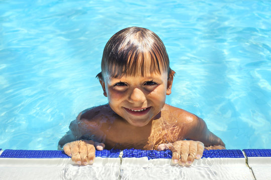 happy little boy swimming in the pool