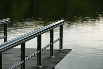 pier at the waterside of the pond in the evening