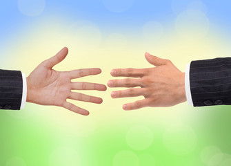 Two hands over bright nature background