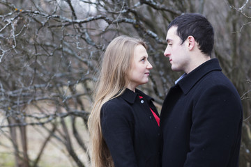 young couple looking to each other in park